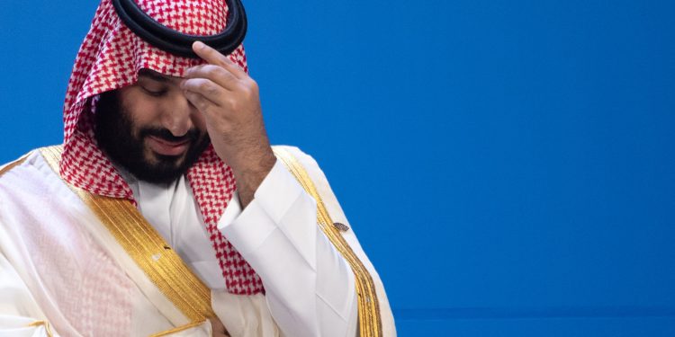 30 November 2018, Argentina, Buenos Aires: Mohammed bin Salman, Saudi Crown Prince, is waiting for the family photo of all participants at the G20 Summit Conference Centre in Buenos Aires. From 30.11.-1.12.2018 the G20 summit will take place in Buenos Aires. The "Group of 20" unites the strongest industrial nations and emerging economies. Photo: Ralf Hirschberger/dpa (Photo by Ralf Hirschberger/picture alliance via Getty Images)