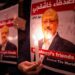 People hold posters picturing Saudi journalist Jamal Khashoggi and lightened candles during a gathering outside the Saudi Arabia consulate in Istanbul, on October 25, 2018. - Jamal Khashoggi, a Washington Post contributor, was killed on October 2, 2018 after a visit to the Saudi consulate in Istanbul to obtain paperwork before marrying his Turkish fiancee. (Photo by Yasin AKGUL / AFP)        (Photo credit should read YASIN AKGUL/AFP via Getty Images)