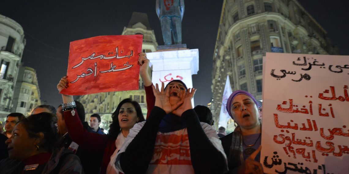 Egyptian protesters hold up placards and shout slogans during a demonstration in Cairo against sexual harassment on February 12, 2013. Egyptian protesters took to the street again to demand an end to sexual violence, as campaigns against the repeated attacks in central Cairo pick up steam. Sexual harassment has long been a problem in Egypt, but recently the violent nature and frequency of the attacks have raised the alarm.   AFP PHOTO / KHALED DESOUKI        (Photo credit should read KHALED DESOUKI/AFP via Getty Images)