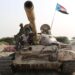TOPSHOT - Fighters of the UAE-trained Security Belt Force, dominated by members of the the Southern Transitional Council (STC) which seeks independence for south Yemen, ride atop a tank in Yemen's southern coastal town of Shuqrah, east of the city of Aden, on August 27, 2019. - Saudi Arabia and the United Arab Emirates renewed a call earlier this week for peace talks between Yemen's government and southern separatists, urging a ceasefire following deadly clashes. (Photo by - / AFP) (Photo by -/AFP via Getty Images)