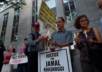 People gather in front of the Embassy of Saudi Arabia on October 2, 2019 in Washington, DC, to remember Jamal Khashoggi, a Saudi journalist and a Washington Post contributing columnist, killed by a team of assassins at the Saudi Arabian consulate in Istanbul. - Amazon founder and Washington Post owner Jeff Bezos joined activists in Istanbul Wednesday for a memorial service outside the Saudi consulate where journalist Jamal Khashoggi was murdered a year ago. (Photo by Olivier Douliery / AFP) (Photo by OLIVIER DOULIERY/AFP via Getty Images)