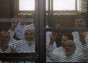 CAIRO, EGYPT - MARCH 6:  Muslim Brotherhood Leader Mohamed Badie (R) and 47 other defendants stand behind bars during the trial of Brotherhood members at a courtroom on March 6, 2014 in Cairo, Egypt. A Cairo court on Thursday adjourned to March 11 the trial of Muslim Brotherhood leader Mohamed Badie and 47 other defendants charged with inciting violence in Egypt's Qalioubiya province last summer, judicial sources said. (Photo by Ahmed Jamil/Anadolu Agency/Getty Images)