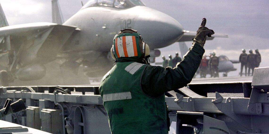 A F-14B "Tomcat" stands ready to launch from the aircraft carrier USS Enterprise November 7, 1998 which is headed to the Persian Gulf. The United States has beefed up its military strength in the Gulf and is threatening airstrikes in an attempt to force Iraq to allow inspections by UNSCOM, which is responsible for eliminating Iraq's weapons of mass destruction. (photo by US Navy)