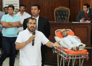 CAIRO, EGYPT - OCTOBER 15:  Father of activist Mohammed Soltan having been hunger strike for some 263 days, Salah Soltan (L), speaks on Egyptian court at his son's trial that accuses him with "misinforming the media" in Cairo, Egypt on October 15, 2014. (Photo by Stringer/Anadolu Agency/Getty Images)