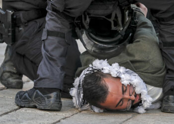 Israeli security forces detain a Palestinian man during a demonstration demanding the release of Palestinians held in Israeli detention facilities, outside the Damascus Gate of the Old City of Jerusalem on March 1, 2022. (Photo by AHMAD GHARABLI / AFP) (Photo by AHMAD GHARABLI/AFP via Getty Images)