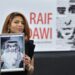 TOPSHOT - Ensaf Haidar holds a picture of her husband Raif Badawi after accepting the European Parliament's Sakharov human rights prize on behalf of her husband, at the European Parliament in Strasbourg, eastern France, on December 16, 2015.  Raif Badawi is a Saudi Arabian blogger and author of a website, detained since 2012 on the charge of breaking Saudi technology laws and insulting religious figures.  / AFP / PATRICK HERTZOG        (Photo credit should read PATRICK HERTZOG/AFP via Getty Images)