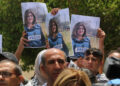 NABLUS, WEST BANK - MAY 11: Press members holding photos of female reporter of Al-Jazeera television channel Shireen Abu Akleh, died as a result of fire opened by Israeli soldiers, are seen in front of the hospital as Akleh's dead body is brought to Al- Najah Hospital for autopsy in Nablus, West Bank on May 11, 2022. (Photo by Nedal Eshtayah/Anadolu Agency via Getty Images)