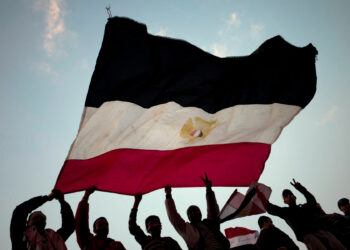 CAIRO, EGYPT - FEBRUARY 11:  Anti-government demonstrators wave an Egyptian flag in Tahrir Square on February 11, 2011 in Cairo, Egypt. After 18 days of widespread protests, Egyptian President Hosni Mubarak, who has now left Cairo for his home in the Egyptian resort town of Sharm el-Sheik, announced that he would step down.  (Photo by Carsten Koall/Getty Images)