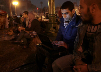 CAIRO, EGYPT - NOVEMBER 26:  Protesters view the internet with a laptop on Tahrir Square on November 26, 2011 in Cairo, Egypt.  Thousands of Egyptians are continuing to occupy Tahrir Square ahead of parliamentary elections to be held on November 28.  (Photo by Etienne De Malglaive/Getty Images)