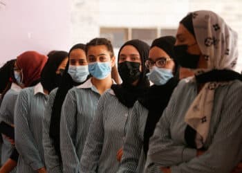 NABLUS, WEST BANK, PALESTINE - 2021/08/31: Palestinian students wearing masks wait to be vaccinated with doses of Pfizer Covid-19 vaccine in the West Bank city of Nablus.
The Palestinian government launched a campaign to vaccinate school students in the West Bank and Gaza Strip to prevent an increase in infections with Covid-19. (Photo by Nasser Ishtayeh/SOPA Images/LightRocket via Getty Images)