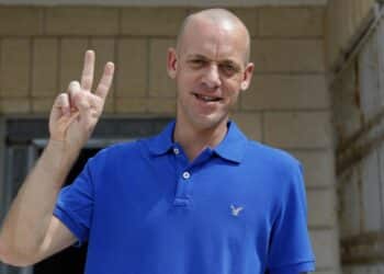 Salah Hamouri, a French-Palestinian lawyer flashes the victory sign at his home in the village of Dahyat al-Barid near Jerusalem in the occupied West Bank, after being released from an Israeli prison on September 30, 2018 - Hamouri, 33, was arrested in Jerusalem on August 23, 2017. He spent most of his detention in a prison in the Negev in southern Israel. The charges against him remained confidential as is generally the case with administrative detentions. (Photo by AHMAD GHARABLI / AFP) (Photo by AHMAD GHARABLI/AFP via Getty Images)