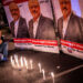 A man mourns by a makeshifts memorial made of candles and posters picturing Saudi journalist Jamal Khashoggi during a gathering outside the Saudi Arabia consulate in Istanbul, on October 25, 2018. - Jamal Khashoggi, a Washington Post contributor, was killed on October 2, 2018 after a visit to the Saudi consulate in Istanbul to obtain paperwork before marrying his Turkish fiancee. (Photo by Yasin AKGUL / AFP)        (Photo credit should read YASIN AKGUL/AFP via Getty Images)