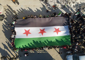 Demonstrators are raising Syrian opposition flags and placards as they rally against a potential rapprochement between Ankara and the Syrian regime in the opposition-held city of Azaz, on the border with Turkey in Syria's northern Aleppo province, on December 30, 2022. (Photo by Rami Alsayed/NurPhoto)