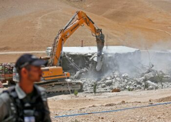 An Israeli bulldozer demolishes a Palestinian house in the Umm Qasas area of Masafer Yatta in the occupied West Bank on July 25, 2022. (Photo by MOSAB SHAWER / AFP) (Photo by MOSAB SHAWER/AFP via Getty Images)