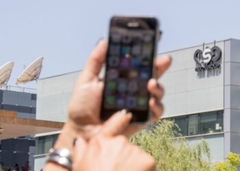 An Israeli woman uses her iPhone in front of the building housing the Israeli NSO group, on August 28, 2016, in Herzliya, near Tel Aviv. - Apple iPhone owners, earlier in the week, were urged to install a quickly released security update after a sophisticated attack on an Emirati dissident exposed vulnerabilities targeted by cyber arms dealers.
Lookout and Citizen Lab worked with Apple on an iOS patch to defend against what was called "Trident" because of its triad of attack methods, the researchers said in a joint blog post.
Trident is used in spyware referred to as Pegasus, which a Citizen Lab investigation showed was made by an Israel-based organization called NSO Group. (Photo by JACK GUEZ / AFP) (Photo by JACK GUEZ/AFP via Getty Images)