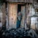 HUWARA, ISRAEL - 2023/02/28: A Palestinian woman looks outside her door that was torched by Jewish settlers in the occupied West Bank town of Huwara. US State Department spokesman Ned Price says the Biden administration expects Israel to prosecute those responsible for Sunday’s deadly settler rampage of Huwara and provide compensation for the Palestinians whose homes and property were destroyed or damaged. (Photo by Eyal Warshavsky/SOPA Images/LightRocket via Getty Images)