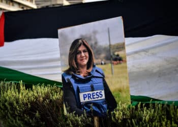 A portrait of slain Al Jazeera reporter Shireen Abu Akleh is pictured during a demonstration in front of the Israeli embassy to support Palestinians, in Athens on May 16, 2022. (Photo by Louisa GOULIAMAKI / AFP) (Photo by LOUISA GOULIAMAKI/AFP via Getty Images)