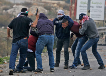 TOPSHOT - Undercover Israeli police arrest Palestinian protestors during clashes following a demonstration in the West Bank city of Ramallah on December 13, 2017, as protests continue in the region amid anger over US President Donald Trump's recognition of Jerusalem as its capital.  / AFP PHOTO / ABBAS MOMANI        (Photo credit should read ABBAS MOMANI/AFP via Getty Images)