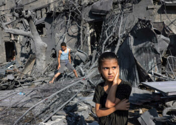 A girl looks on as she stands by the rubble outside a building that was hit by Israeli bombardment in Rafah in the southern Gaza Strip on October 31, 2023 amid ongoing battles between Israel and the Palestinian Hamas movement. (Photo by MOHAMMED ABED / AFP)