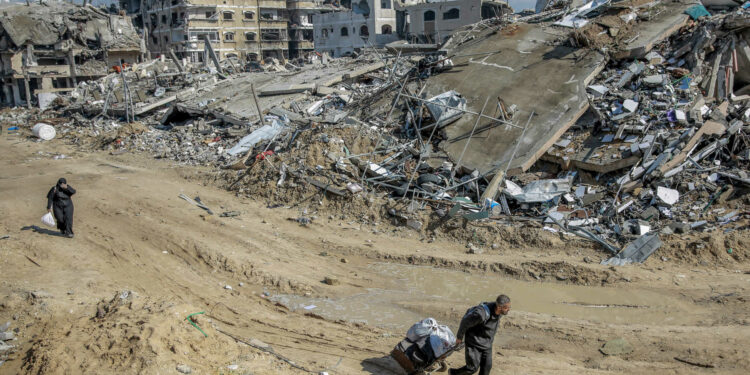 People look for salvageable items at Al-Maqoussi towers area on February 3, 2024, amid the rubble of buildings destroyed during Israeli bombardment on Gaza City, as battles continue between Israel and the Palestinian militant group Hamas. (Photo by AFP)