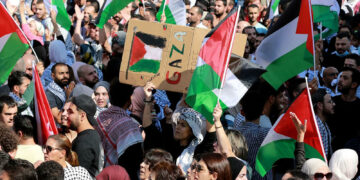 Jordanians shout slogans and wave flags during a protest outside the Israeli embassy in Amman following a strike which ripped through a Gaza hospital compound killing hundreds on October 17, 2023. Thousands rallied across the Arab world on October 18 to protest the deaths of hundreds of people in a strike on a Gaza hospital they blame on Israel, despite its denials. (Photo by Khalil MAZRAAWI / AFP) (Photo by KHALIL MAZRAAWI/AFP via Getty Images)