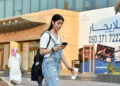 Saudi Manahel al-Otaibi, a 25-year-old activist, checks her mobile as she walks in western clothes in the Saudi capital Riyadh's al Tahliya street on September 2, 2019. - With her high heels clacking on marble tiles, a defiant Saudi woman turned heads and drew gasps as she strutted down a Riyadh mall -- without a body-shrouding abaya. The billowy robe, commonly all-black, is an over-garment that is customary in public for women in the ultra-conservative Islamic kingdom, where it is widely seen as a symbol of piety. Last year, de facto ruler Crown Prince Mohammed bin Salman hinted the dress code may be relaxed amid his sweeping liberalisation drive, saying the robe was not mandatory in Islam. (Photo by FAYEZ NURELDINE / AFP)        (Photo credit should read FAYEZ NURELDINE/AFP via Getty Images)