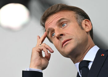 France's President Emmanuel Macron gestures ahead of the opening ceremony of the Paris 2024 Olympic Games in Paris on July 26, 2024. (Photo by Fabrice COFFRINI / AFP) (Photo by FABRICE COFFRINI/AFP via Getty Images)