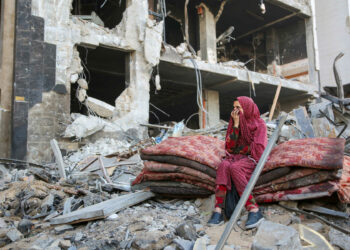 A Palestinian woman reacts as she sits amidst the rubble of Gaza's Al-Shifa hospital after the Israeli military withdrew from the complex housing the hospital on April 1, 2024, amid the ongoing battles Israel and the Hamas militant group. (Photo by AFP)