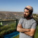 Tzvi Succot, the 29-year-old son of an ultra-Orthodox family, poses for a picture outside his home in the settlement of Yitzhar south of the Palestinian city of Nablus in the occupied West Bank, on June 22, 2020. - The 450,000 Israeli settlers in the occupied West Bank are a diverse group ranging from ultra-Orthodox to secular moderates, who hold varying views on Israel's impending decision on annexation. From July 1, the Israeli government aims to take first steps toward implementing part of a US-proposed Middle East peace plan that paves the way for annexing key parts of the West Bank, including settlements long considered illegal by the majority of the international community. (Photo by MENAHEM KAHANA / AFP) (Photo by MENAHEM KAHANA/AFP via Getty Images)