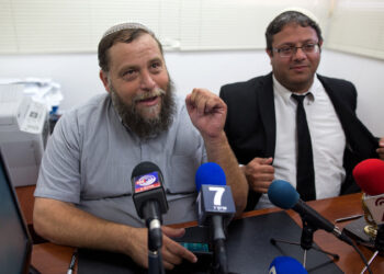 Israeli leader of the extreme right-wing movement Lehava, Organization for Prevention of Assimilation in the Holy Land, Benzi Gopstein (L) talks to journalists next to his lawyer Itamar Ben Gvir on August 11, 2015 in Jerusalem after Israel police questioned him as he condoned torching churches amid an uproar over recent hate crimes, including the deadly firebombing of a Palestinian home. Benzi Gopstein has not been linked to any recent attacks, but his comments regarding churches came at a time of heightened sensitivity over Jewish extremism and drew outrage from Roman Catholic officials. AFP PHOTO / MENAHEM KAHANA (Photo by MENAHEM KAHANA / AFP) (Photo by MENAHEM KAHANA/AFP via Getty Images)