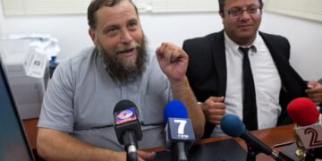 Israeli leader of the extreme right-wing movement Lehava, Organization for Prevention of Assimilation in the Holy Land, Benzi Gopstein (L) talks to journalists next to his lawyer Itamar Ben Gvir on August 11, 2015 in Jerusalem after Israel police questioned him as he condoned torching churches amid an uproar over recent hate crimes, including the deadly firebombing of a Palestinian home. Benzi Gopstein has not been linked to any recent attacks, but his comments regarding churches came at a time of heightened sensitivity over Jewish extremism and drew outrage from Roman Catholic officials. AFP PHOTO / MENAHEM KAHANA (Photo by MENAHEM KAHANA / AFP) (Photo by MENAHEM KAHANA/AFP via Getty Images)