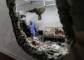 People inspect the damage in a room following Israeli bombardment at Nasser hospital in Khan Yunis in the southern Gaza Strip on December 17, 2023, amid ongoing battles between Israel and the Palestinian militant group Hamas. (Photo by STRINGER / AFP)