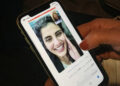 This picture taken February 10, 2021 in Saudi Arabia's capital Riyadh shows a woman viewing a tweet posted by the sister of Saudi activist Loujain al-Hathloul, Lina, showing a screenshot of them having a video call following Hathloul's release after nearly three years in detention. Saudi authorities on February 10 released the prominent women's rights activist, her family said, as the kingdom comes under renewed US pressure over its human rights record. Hathloul, 31, was arrested in May 2018 with about a dozen other women activists just weeks before the historic lifting of a decades-long ban on female drivers, a reform they had long campaigned for, sparking a torrent of international criticism. (Photo by Fayez Nureldine / AFP) (Photo by FAYEZ NURELDINE/AFP via Getty Images)