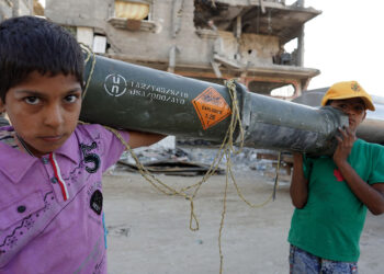 TOPSHOT - Palestinian children carry an empty US ammunition container in Khan Yunis in the southern Gaza Strip on May 16, 2024, amid the ongoing conflict between Israel and the militant group Hamas. (Photo by AFP) (Photo by -/AFP via Getty Images)