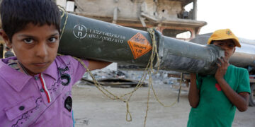 TOPSHOT - Palestinian children carry an empty US ammunition container in Khan Yunis in the southern Gaza Strip on May 16, 2024, amid the ongoing conflict between Israel and the militant group Hamas. (Photo by AFP) (Photo by -/AFP via Getty Images)