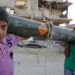 TOPSHOT - Palestinian children carry an empty US ammunition container in Khan Yunis in the southern Gaza Strip on May 16, 2024, amid the ongoing conflict between Israel and the militant group Hamas. (Photo by AFP) (Photo by -/AFP via Getty Images)