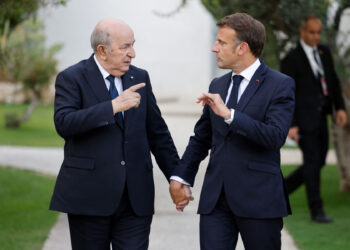 France's President Emmanuel Macron (R) and Algeria's President Abdelmadjid Tebboune (L) gesture towards each other as they attend the G7 Summit hosted by Italy at the Borgo Egnazia resort in Apulia region, in Savelletri on June 13, 2024. Leaders of the G7 wealthy nations gather in southern Italy this week against the backdrop of global and political turmoil, with boosting support for Ukraine top of the agenda. (Photo by Ludovic MARIN / AFP)