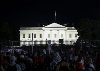 WASHINGTON D.C., UNITED STATES - JUNE 08: Demonstrators, wearing red clothes, hold banners and chant slogans in front of the White House as some of the pro-Palestinian demonstrators, gathered in front of the White House and called on the Joe Biden administration to 'red line', set up many tents in the area between the White House and the Washington Monument in the evening in Washington D.C, United States on June 08, 2024. (Photo by Fatih Aktas/Anadolu via Getty Images)