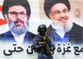 A member of security forces loyal to Yemen's Huthi group stands guard before a banner depicting Lebanese Hezbollah's slain leaders Hassan Nasrallah and Hashem Safieddine during an anti-Israel rally in solidarity with Gaza and Lebanon in the Huthi-controlled capital Sanaa on October 25, 2024. (Photo by Mohammed HUWAIS / AFP)