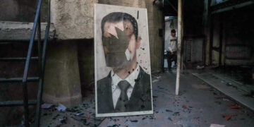 A defaced portrait of ousted Syrian president Bashar al-Assad stands in a ransacked government security facility, in Damascus, on December 8, 2024. Islamist-led rebels declared on December 8, that they have taken the Syrian capital in a lightning offensive, sending President Bashar al-Assad fleeing and ending five decades of Baath rule in Syria. (Photo by Rami al SAYED / AFP)