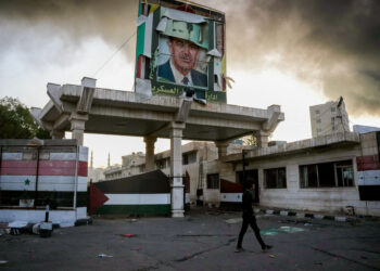 A defaced portrait of late Syrian president Hafez al-Assad stands above a ransacked government security facility, in Damascus, on December 8, 2024. Islamist-led rebels declared on December 8, that they have taken the Syrian capital in a lightning offensive, sending President Bashar al-Assad fleeing and ending five decades of Baath rule in Syria. (Photo by Rami al SAYED / AFP)