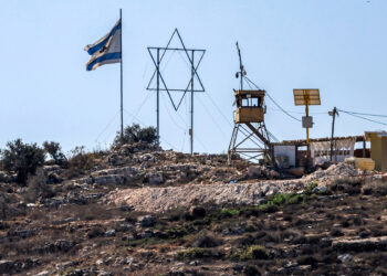 An Israeli flag and a giant Star of David are displayed next to an Israeli watchtower in the Eviatar settlement outpost opposite the village of Beita, south of Nablus in the occupied West Bank, on October 19, 2024. (Photo by JAAFAR ASHTIYEH / AFP) (Photo by JAAFAR ASHTIYEH/AFP via Getty Images)