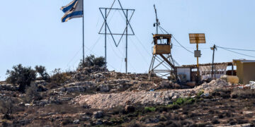 An Israeli flag and a giant Star of David are displayed next to an Israeli watchtower in the Eviatar settlement outpost opposite the village of Beita, south of Nablus in the occupied West Bank, on October 19, 2024. (Photo by JAAFAR ASHTIYEH / AFP) (Photo by JAAFAR ASHTIYEH/AFP via Getty Images)