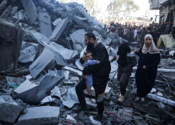 Palestinians inspect damage at the site of an Israeli strike on a house amid the Israel-Hamas conflict at the Nuseirat refugee camp in the central Gaza Strip on December 13, 2024. (Photo by Majdi Fathi/NurPhoto via Getty Images)