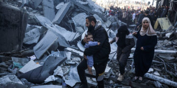 Palestinians inspect damage at the site of an Israeli strike on a house amid the Israel-Hamas conflict at the Nuseirat refugee camp in the central Gaza Strip on December 13, 2024. (Photo by Majdi Fathi/NurPhoto via Getty Images)