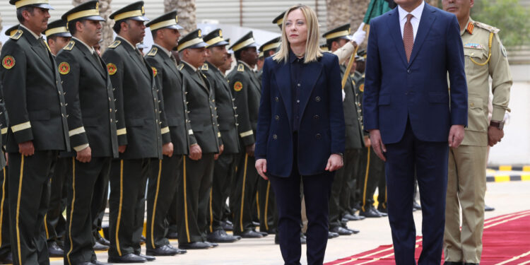 Libya's interim Prime Minister Abdulhamid Dbeibah (R) welcomes Italy's Prime Minister Giorgia Meloni as she arrives for a meeting in Tripoli on May 7, 2024. (Photo by Mahmud Turkia / AFP)