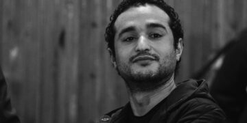 (FILES) Leading Egyptian opposition campaigner Ahmed Douma listens to the verdict in court during his trial, along with 230 activists from the 2011 revolt against Hosni Mubarak, all sentenced to life in prison on February 4, 2015 in Cairo. Egypt's president pardoned jailed activist Ahmed Douma, his lowyers said. (Photo by AFP)