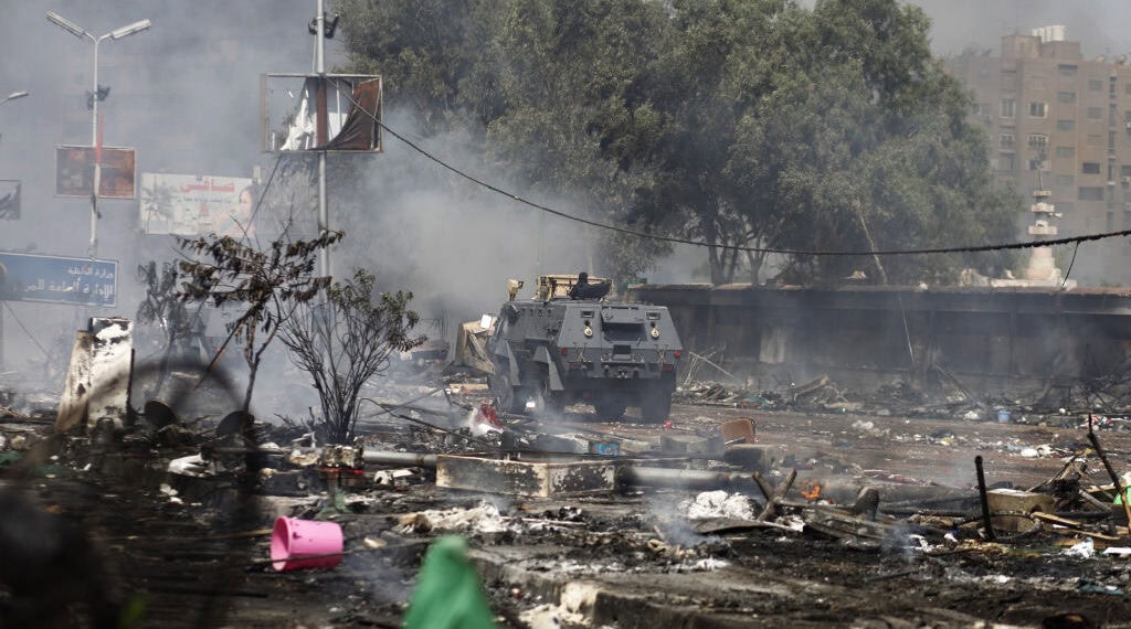 An Egyptian security forces' armoured vehicle drives amidst the remains of a protest camp set up by supporters of ousted president Mohamed Morsi and members of the Muslim Brotherhood after a crackdown on August 14, 2013 near Cairo's Rabaa al-Adawiya mosque. Security forces moved in on two huge Cairo protest camps set up by supporters of Egypt's ousted president Mohamed Morsi, launching a crackdown that quickly turned into a bloodbath with dozens dead. AFP PHOTO / MAHMOUD KHALED        (Photo credit should read MAHMOUD KHALED/AFP via Getty Images)
