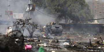 An Egyptian security forces' armoured vehicle drives amidst the remains of a protest camp set up by supporters of ousted president Mohamed Morsi and members of the Muslim Brotherhood after a crackdown on August 14, 2013 near Cairo's Rabaa al-Adawiya mosque. Security forces moved in on two huge Cairo protest camps set up by supporters of Egypt's ousted president Mohamed Morsi, launching a crackdown that quickly turned into a bloodbath with dozens dead. AFP PHOTO / MAHMOUD KHALED        (Photo credit should read MAHMOUD KHALED/AFP via Getty Images)