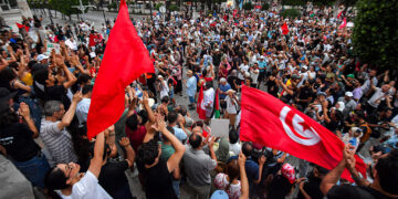 People gather to protest Tunisia's President Kais Saied during a demonstration marking five years since his suspension of parliament and assumption of emergency powers, along Avenue Habib Bourguiba in Tunis on July 25, 2026. (Photo by FETHI BELAID / AFP via Getty Images)